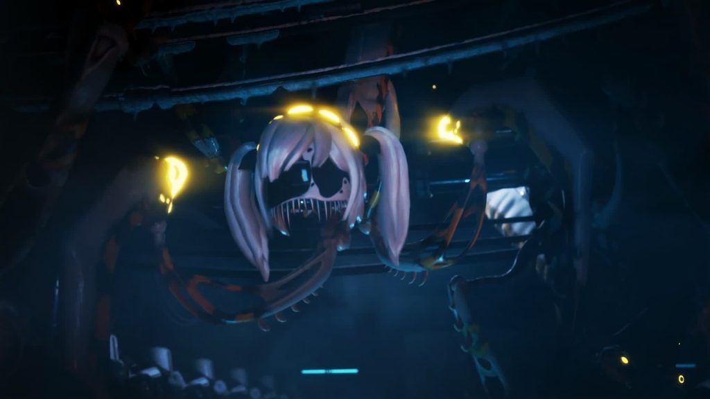 Eldritch J подвешена щупальцеподобными придатками, светящимися жёлтым светом в тёмной комнате